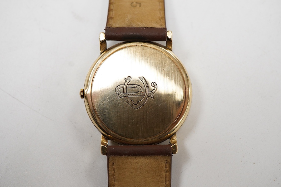 A gentleman's late 20th century Longines 9ct gold quartz wrist watch, with baton numerals and date aperture, the case back with engraved monogram, case diameter 32mm, on an associated leather strap, no box or papers.
